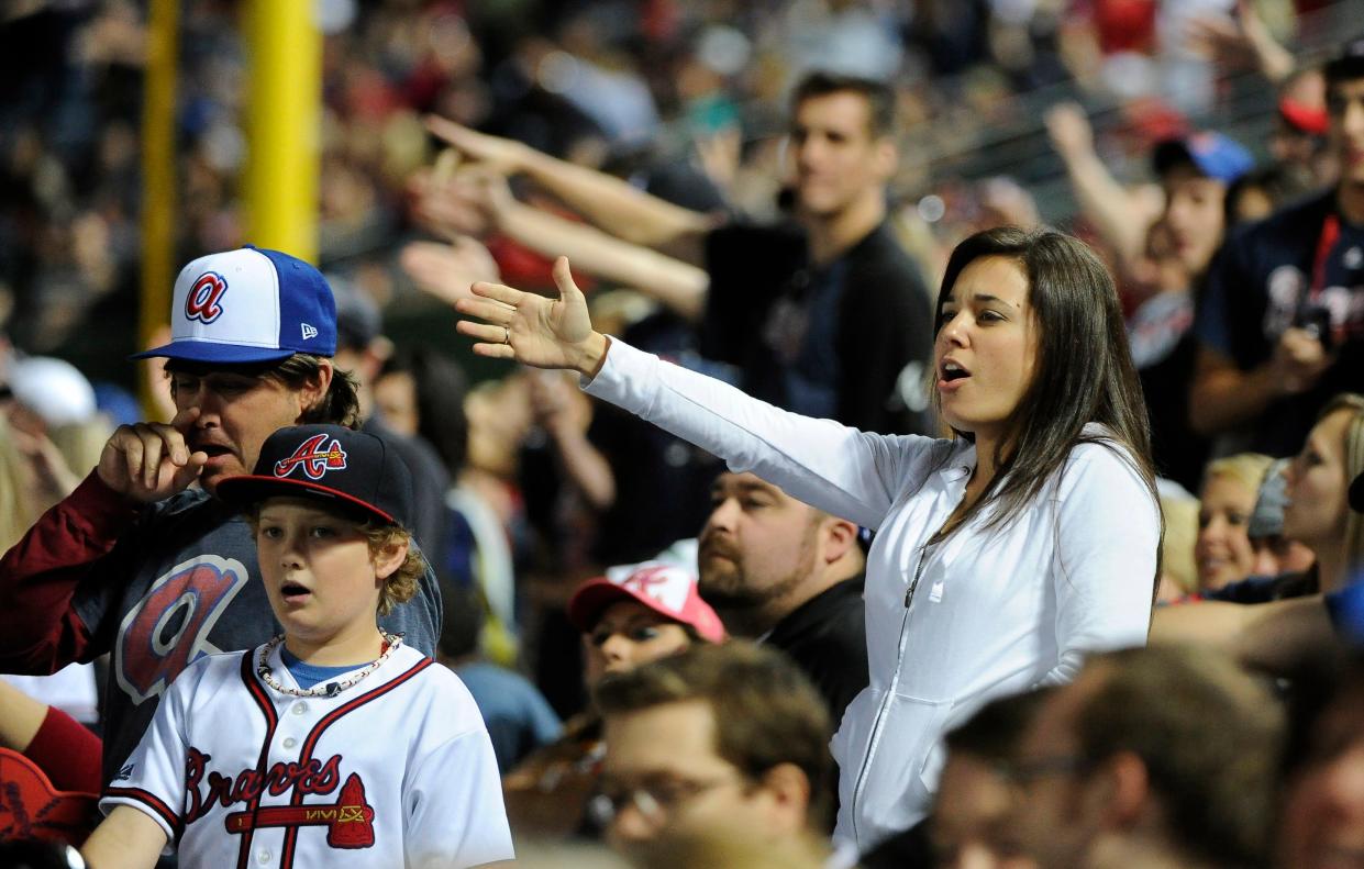 In this May 2, 2014, file photo, Atlanta Braves fans do the tomahawk chop during the ninth inning of a baseball game with the San Francisco Giants, in Atlanta.