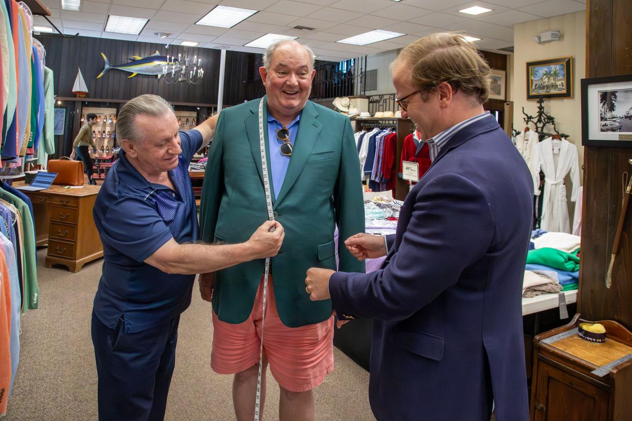 Michael Maus, right, of Maus and Hoffman works with master tailor Joao Batista, left, to fit customer Cortie Wetherill with an Italian-made Solemare hopsack blazer on April 26.