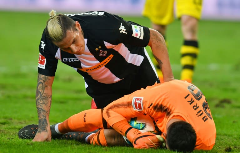 Ground for concern: Moenchengladbach's Raul Bobadilla with Dortmund goalkeeper Roman Buerki