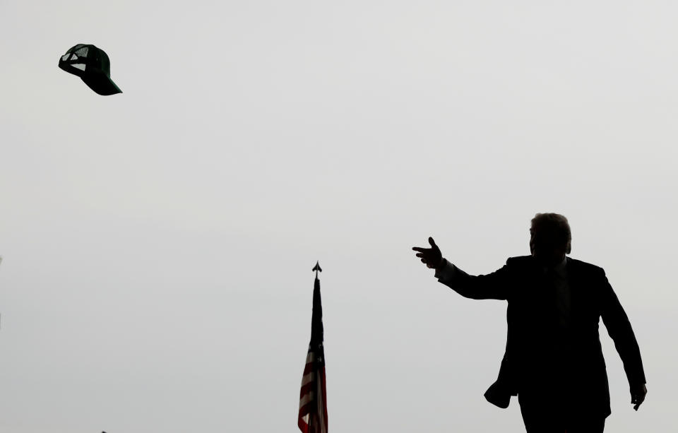 U.S. President Donald Trump tosses a hat into the crowd as he arrives to speak at Marine Corps Air Station Miramar in San Diego, California, U.S. March 13, 2018. REUTERS/Kevin Lamarque TPX IMAGES OF THE DAY