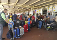 British passengers with Thomas Cook wait in queue at Antalya airport in Antalya, Turkey, Monday Sept. 23, 2019. Hundreds of thousands of travellers were stranded across the world Monday after British tour company Thomas Cook collapsed, immediately halting almost all its flights and hotel services and laying off all its employees. According to reports Monday morning some 21,000 Thomas Cook travellers were stranded in Turkey alone.(DHA via AP)