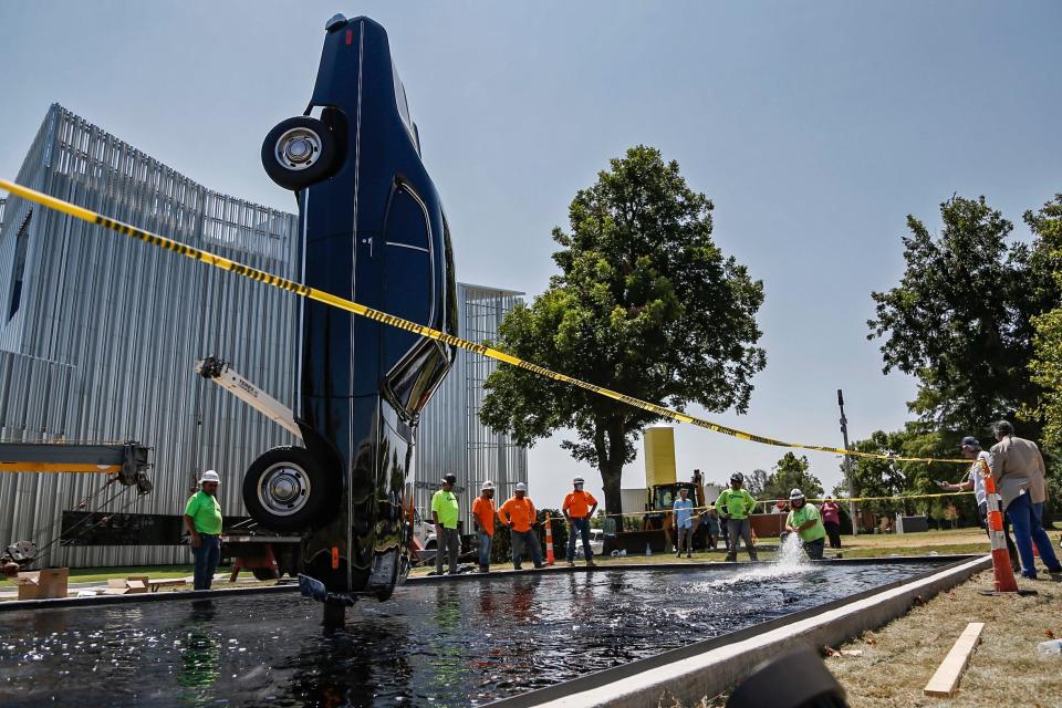 A team works Tuesday, Aug. 2, 2022, to install "Breve historia del tiempo," a sculpture by Mexican artist Gonzalo Lebrija's, at Campbell Art Park at Oklahoma Contemporary Arts Center on Automobile Alley in Oklahoma City.