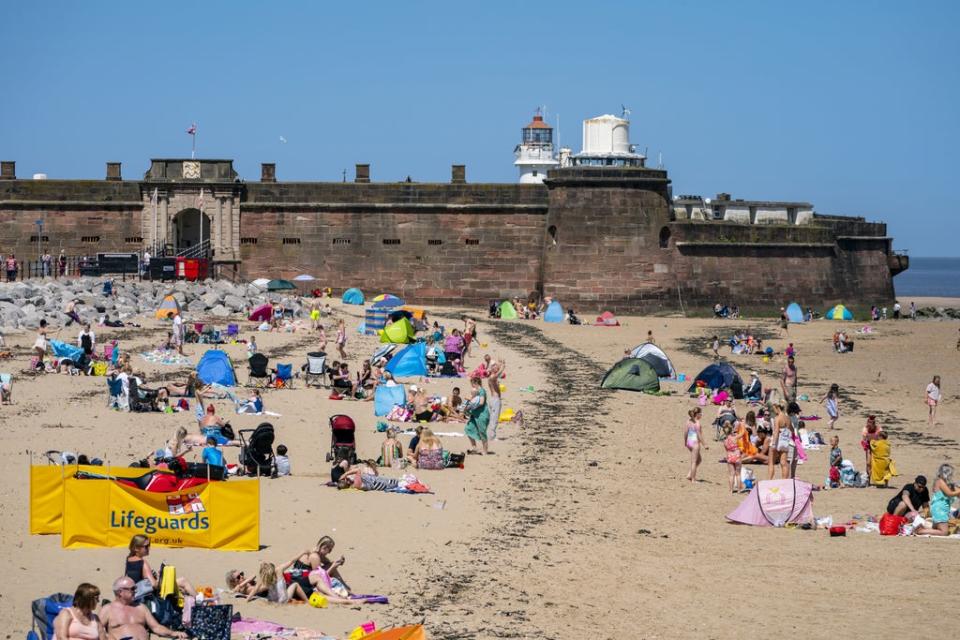 Sunbathers at New Brighton (Peter Byrne/PA) (PA Archive)