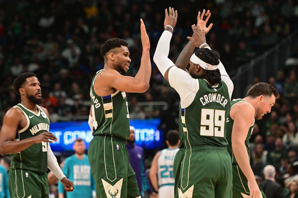 Feb 27, 2024; Milwaukee, Wisconsin, USA; Milwaukee Bucks forward Giannis Antetokounmpo (34) celebrates with forward Jae Crowder (99) in the third quarter against the Charlotte Hornets at Fiserv Forum. Mandatory Credit: Benny Sieu-USA TODAY Sports