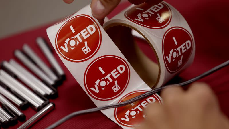 Voters are offered “I voted” stickers at the Salt Lake County Government Center in Salt Lake City on Nov. 21, 2023. 