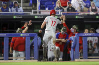 Philadelphia Phillies' Rhys Hoskins is congratulated after scoring against the Toronto Blue Jays during the seventh inning of a baseball game Friday, May 14, 2021, in Dunedin, Fla. (AP Photo/Mike Carlson)