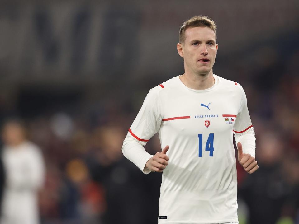 Jakub Jankto running on a soccer field while wearing a tight-fitting white top with the number 14 on the front.