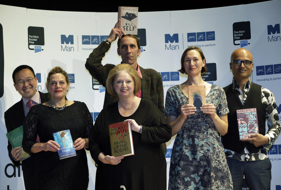 FILE - From left, authors, Malaysian Tan Twan Eng, Deborah Levy, Hilary Mantel, Will Self, holding his book, top, Alison Moore and Jeet Thayil, from India, shortlisted for the Man Booker Prize, hold copies of their books during a photo call at the Royal Festival Hall, in London, on Oct. 15, 2012. Hilary Mantel, the Booker Prize-winning author of the acclaimed “Wolf Hall” saga, has died, publisher HarperCollins said Friday Sept. 23, 2022. She was 70. (AP Photo/Lefteris Pitarakis, File)