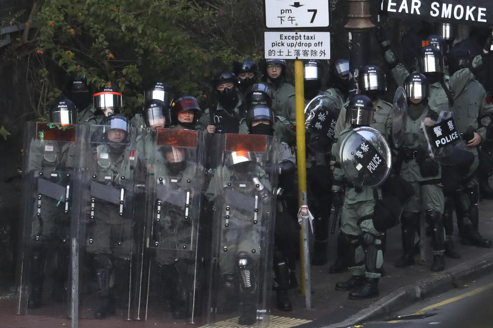 Riot police stand guard as they face off with pro-democracy protesters at the campus of the Hong Kong Polytechnic University, in Hong Kong, Thursday, Nov. 14, 2019. University students from mainland China and Taiwan are fleeing Hong Kong, while those from three Scandinavian countries have been moved or urged to leave as college campuses become the latest battleground in the city's 5-month-long anti-government unrest. (AP Photo/Ng Han Guan)