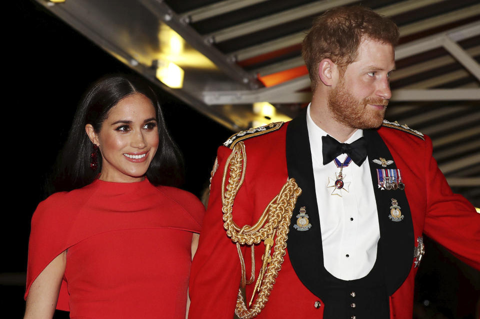 FILE - In this Saturday March 7, 2020 file photo, Britain's Prince Harry and Meghan, Duchess of Sussex arrive at the Royal Albert Hall in London, , to attend the Mountbatten Festival of Music. Prince William infuriated Prince Harry when he told his younger brother he should move slowly in his relationship with the former Meghan Markle, fearing that he was being “blindsided by lust,’’ a new book on the Windsors says. The second installment of a serialized version of the book “Finding Freedom,” which appeared in the Sunday Times, Sunday, July 26, 2020 claimed that Harry was angered by what he perceived to be as William’s snobby tone in a discussion about the American actress. (Simon Dawson/Pool via AP, file)