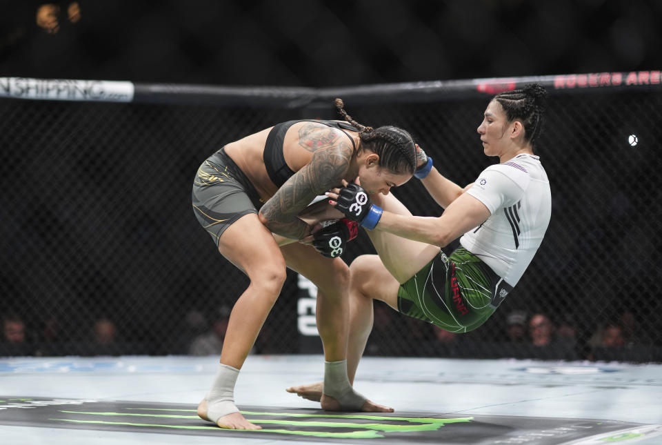 Amanda Nunes, left, and Irene Aldana fight during a UFC 289 women's bantamweight title bout, in Vancouver, British Columbia, on Saturday, June 10, 2023. (Darryl Dyck/The Canadian Press via AP)