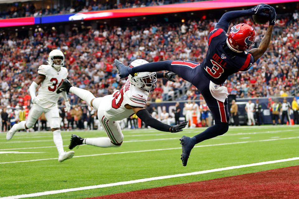 Tank Dell #3 of the Houston Texans catches a pass for a touchdown in front of Marco Wilson #20 of the Arizona Cardinals during the second quarter at NRG Stadium on Nov. 19, 2023, in Houston, Texas.