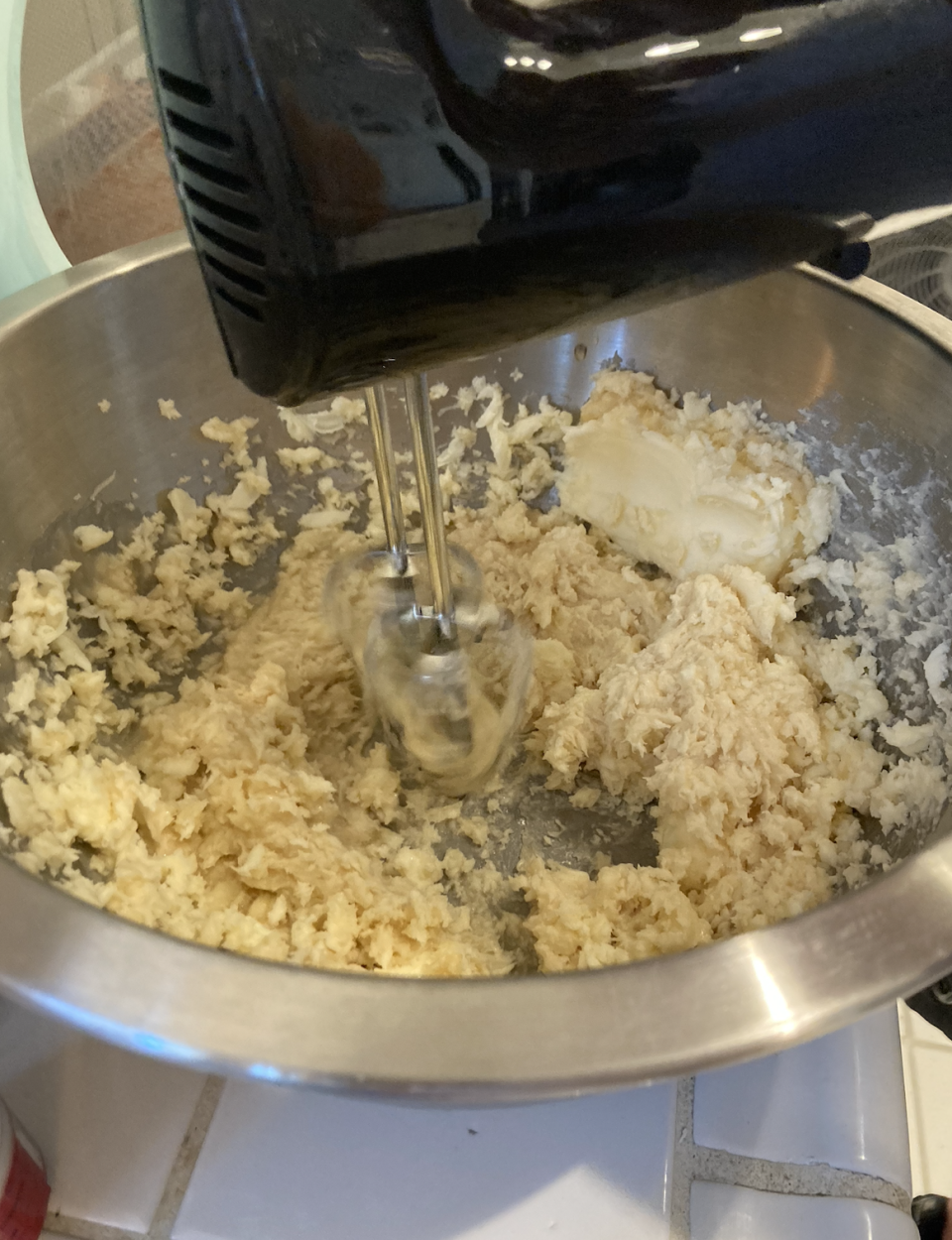 hand mixer mixing in a large bowl