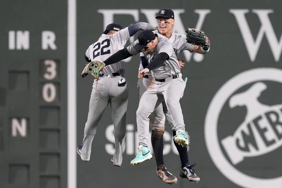 New York Yankees outfielders Juan Soto, Alex Verdugo and Aaron Judge, from left, celebrate after the team's win over the Boston Red Sox in a baseball game Friday, June 14, 2024, in Boston. (AP Photo/Michael Dwyer)