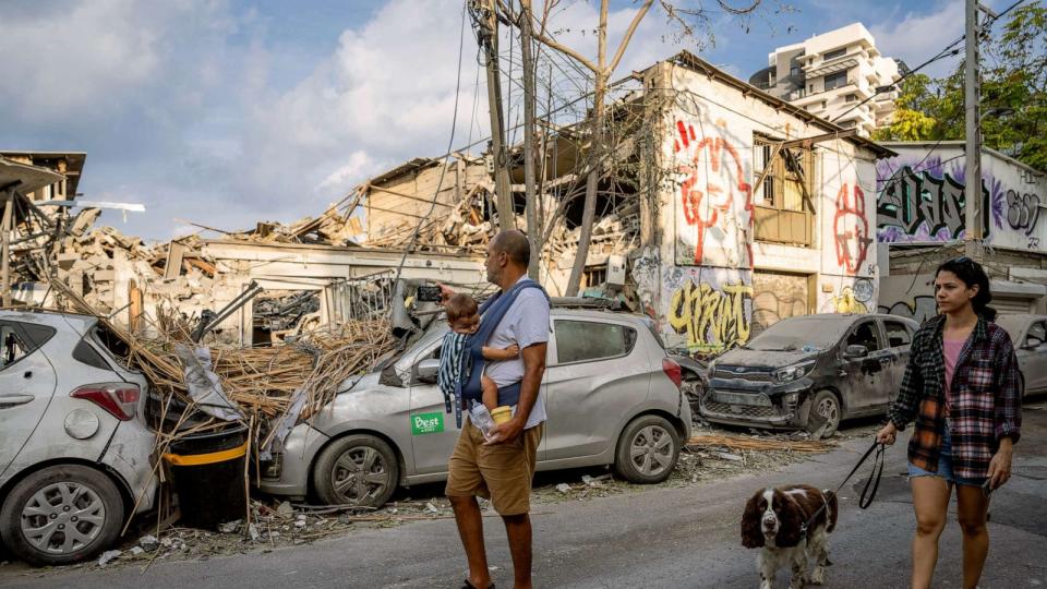 PHOTO: Israelis inspect the rubble of a building a day after it was hit by a rocket fired from the Gaza Strip, in Tel Aviv, Israel, Oct. 8, 2023. (Oded Balilty/AP)