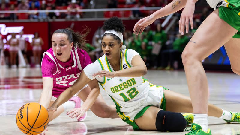 Utah Utes guard Kennady McQueen (24) and Oregon Ducks guard Kennedi Williams (12) fight to reach the ball during a game at the Huntsman Center in Salt Lake City on Saturday, Feb. 11, 2023.