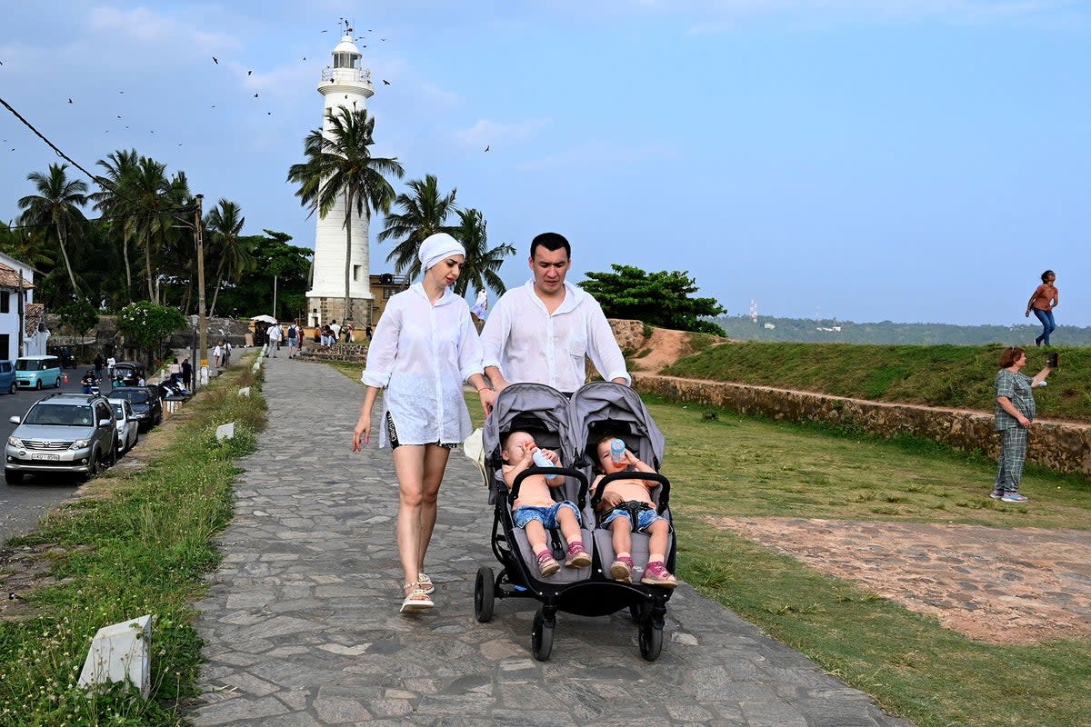 Tourists walk by the coast in Galle, Sri Lanka (AFP/Getty)