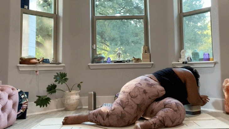 Woman stretching in a twist on her yoga mat