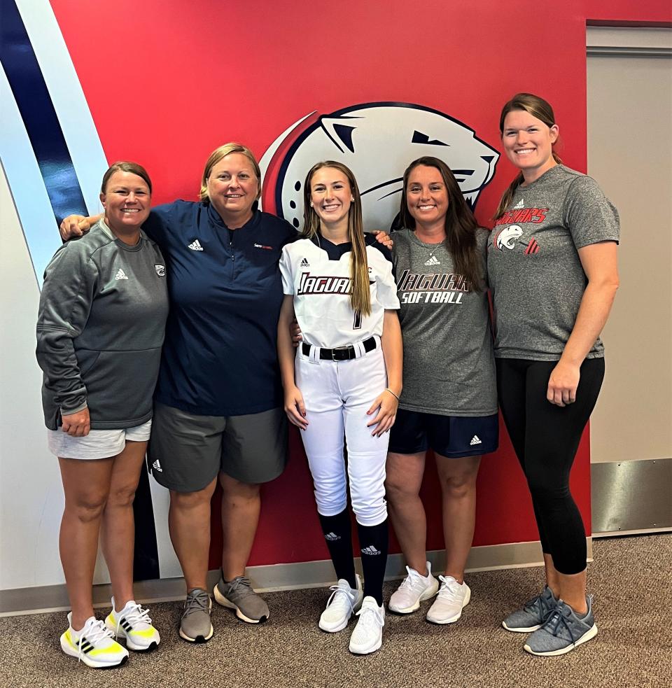 Jay infielder Caitlyn Gavin (center) poses with South Alabama softball coaching staff after announcing her commitment to play softball with the Jaguars on Monday, July 18, 2022.