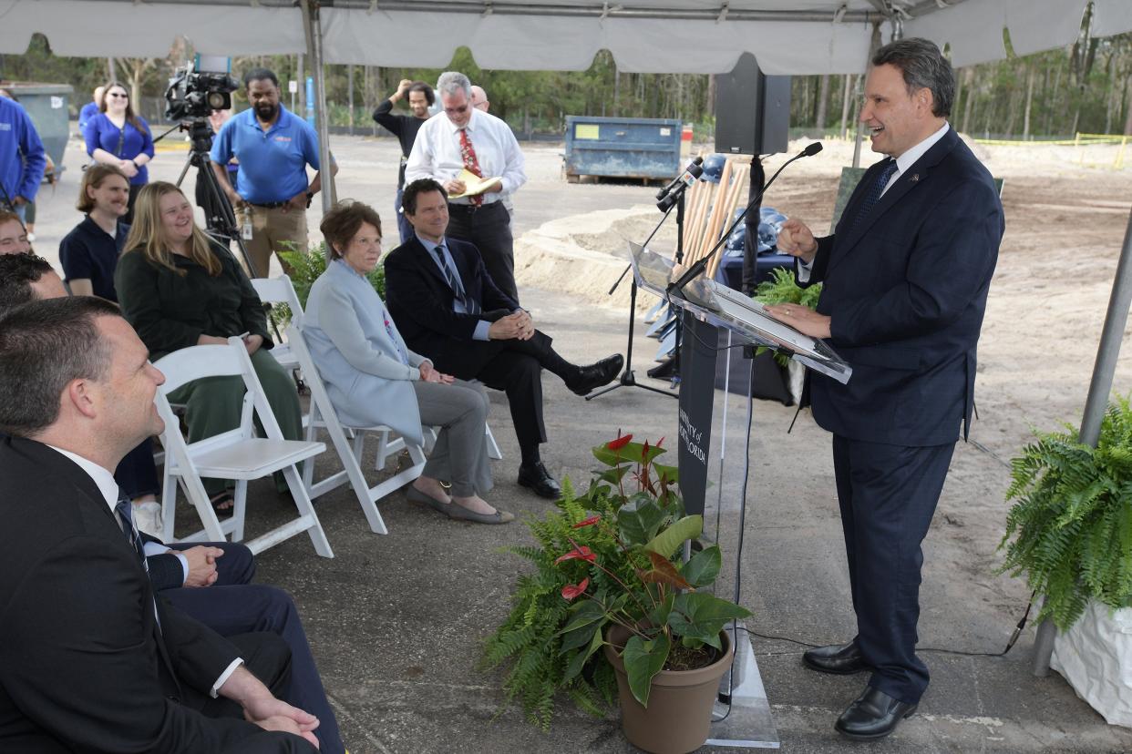 University of North Florida President Moez Limayem talks to guests at a groundbreaking ceremony for the new residence hall at the Hicks Honors College. The 521-bed project is an early step in a state-approved plan to boost enrollment to 25,000 students, about 8,000 more than now, by 2028. The new housing will be adjacent to the Osprey Fountains dorm on the campus's eastern edge.