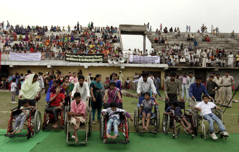 Indian children suffering with birth defects compete in a wheel chair race during a "Special Olympics" held by the survivors of the deadly 1984 Bhopal gas leak in an effort to shame Olympic sponsor Dow Chemical Co. on the eve of the London Games in Bhopal, India, Thursday, July 26, 2012. Survivors say Dow owes them compensation for the world's worst industrial disaster and have campaigned to have the chemical giant dropped as a sponsor of the Olympics. Dow says it has no liability because it bought the company responsible for the plant more than a decade after the cases had been settled. (AP Photo/Altaf Qadri)