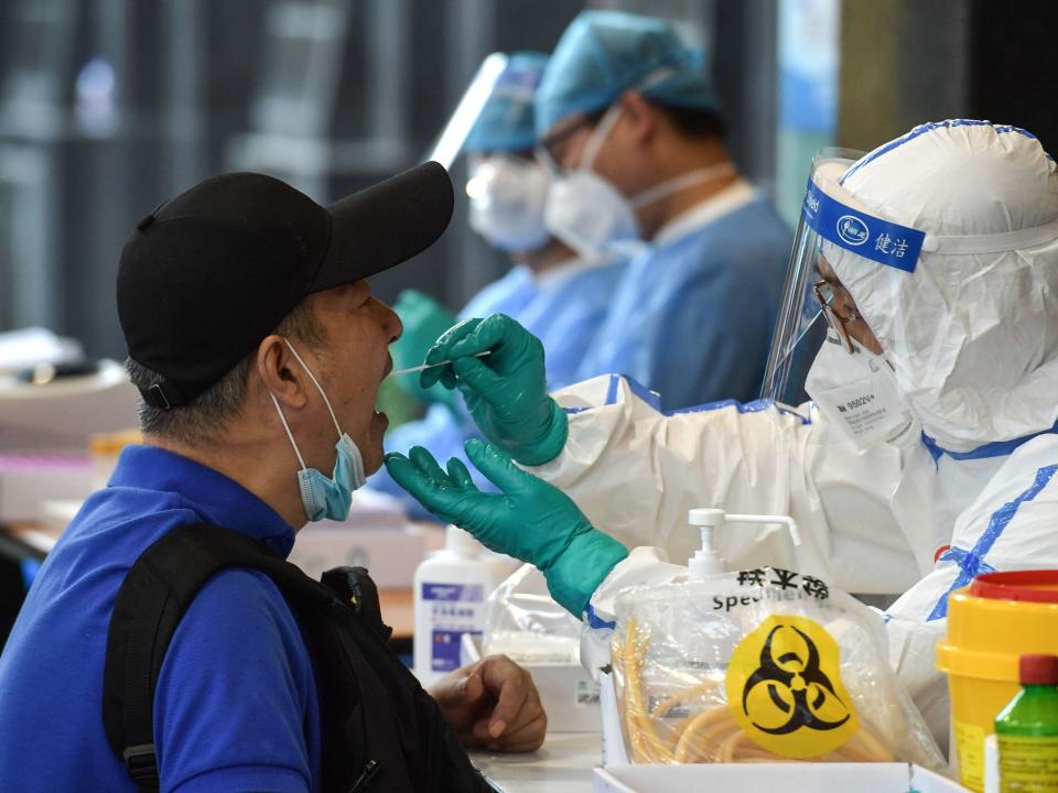 A man, who visited Beijing recently, is tested for the COVID-19 coronavirus in Nanjing in China's eastern Jiangsu province on June 15, 2020. - China's capital city raced on June 15 to control a fresh coronavirus outbreak, with 75 cases linked to a single wholesale food market in Beijing where authorities have locked down neighbourhoods and launched a massive test and trace programme. (Photo by STR / AFP) / China OUT (Photo by STR/AFP via Getty Images)