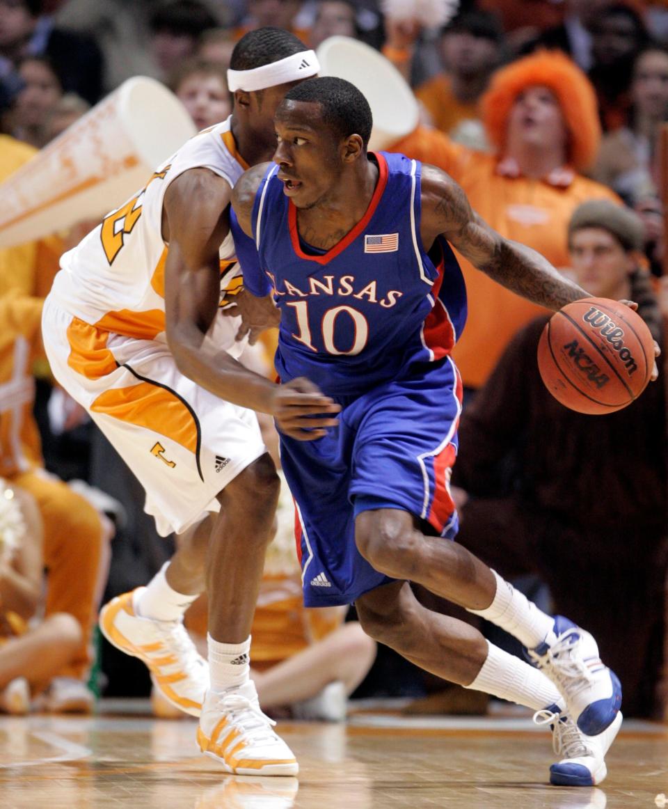 Kansas' Tyshawn Taylor (10) drives to the basket against Tennessee's Scotty Hopson (32) during the second half of an NCAA college basketball game Sunday, Jan. 10, 2010, in Knoxville, Tenn. Tennessee won 76-68.