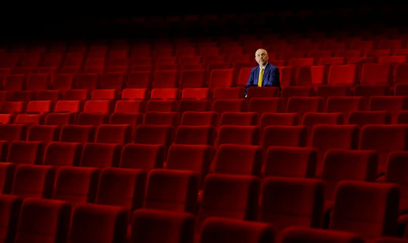 A staff member sits inside an empty cinema in Karlovy Vary