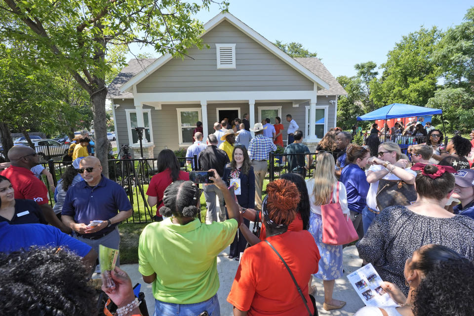 People gather outside Opal Lee's new house in Fort Worth, Texas, Friday, June 14, 2024. Habitat for Humanity built Lee the home on the same lot where, as a child, a white mob destroyed her family's home driving them away. (AP Photo/LM Otero)