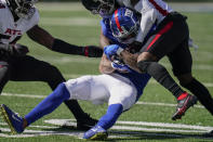 New York Giants wide receiver Kenny Golladay (19) is tackled by Atlanta Falcons defensive back T.J. Green, right, during the second half of an NFL football game, Sunday, Sept. 26, 2021, in East Rutherford, N.J. (AP Photo/Seth Wenig)