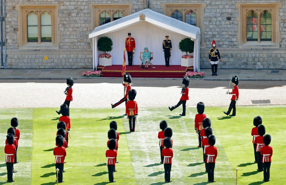 WINDSOR, UNITED KINGDOM - JUNE 13: (EMBARGOED FOR PUBLICATION IN UK NEWSPAPERS UNTIL 24 HOURS AFTER CREATE DATE AND TIME) Queen Elizabeth II attends a military ceremony in the Quadrangle of Windsor Castle to mark her Official Birthday on June 13, 2020 in Windsor, England. It was decided that due to the ongoing COVID-19 Pandemic The Queen's Birthday Parade, known as Trooping the Colour, would not go ahead in it's traditional form at Buckingham Palace and Horse Guards Parade, but a small military ceremony in line with the Government's Social Distancing Guidelines would take place at Windsor Castle instead. Soldiers of 1st Battalion Welsh Guards (whose Colour was due to be Trooped this year) will carry out a series of military drills and Royal Salute. (Photo by Max Mumby/Indigo/Getty Images)