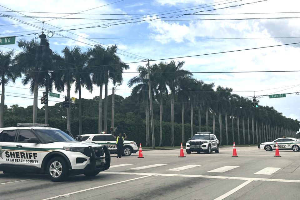 Four sheriff's vehicles parked on the road near Trump International Golf Club.