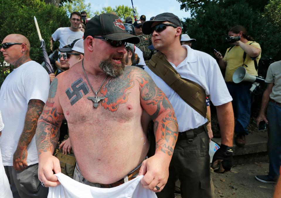 A white supremacist with a Nazi tattoo leaves Emancipation Park in Charlottesville, Va., Aug. 12, 2017.