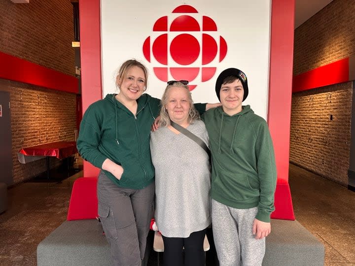 From left: Dylan, Daphne and Dustin Rendell came together as a family over Christmas when Dustin was adopted alongside four of his new siblings in December. (Sarah Antle/CBC - image credit)