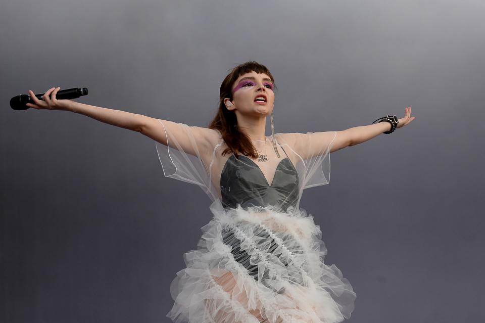 At the Latitude Festival, Lauren Mayberry wears Roberts-Wood’s white non-stitched Vortex dress made, writes the designer, “using pattern cutting to engineer a single pattern piece that twists and rotates as it is assembled to form the whirling design.”