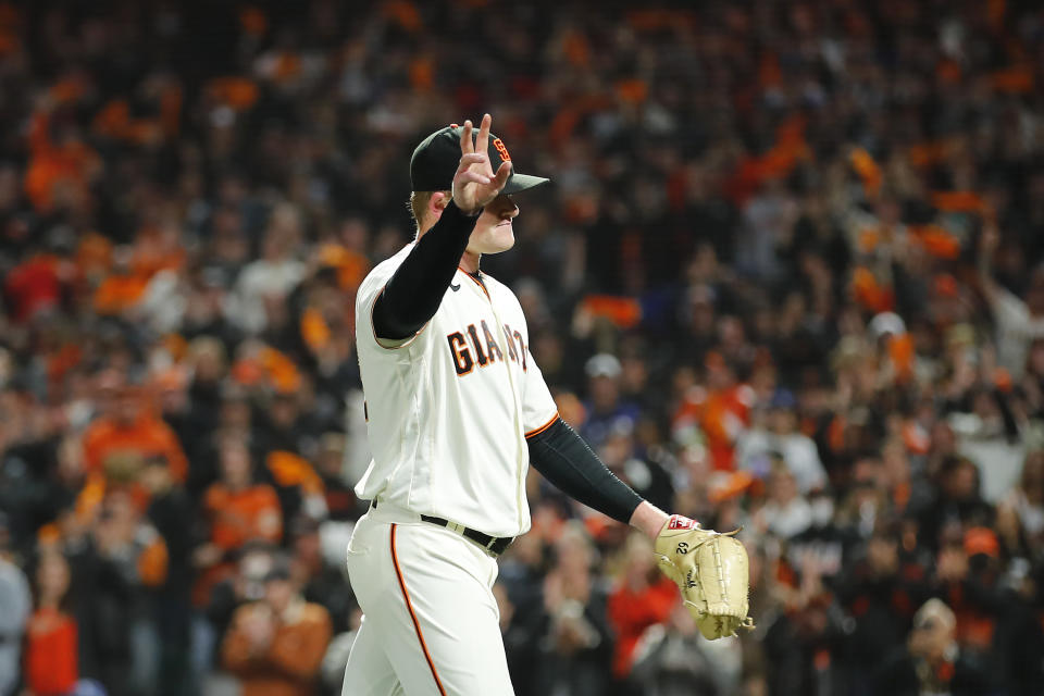 San Francisco Giants pitcher Logan Webb waves as he walks toward the dugout after being relieved during the eighth inning of Game 1 of a baseball National League Division Series against the Los Angeles Dodgers Friday, Oct. 8, 2021, in San Francisco. (AP Photo/John Hefti)