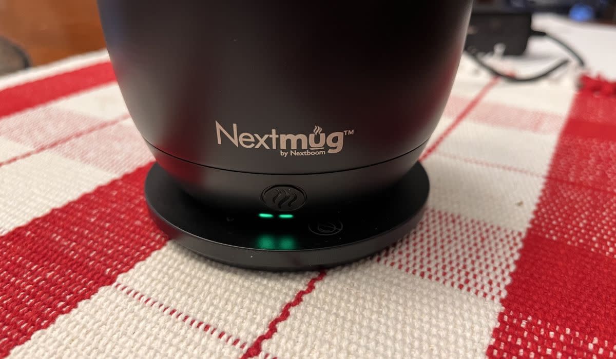 A close-up of the Nextmug's power button and battery LEDs.