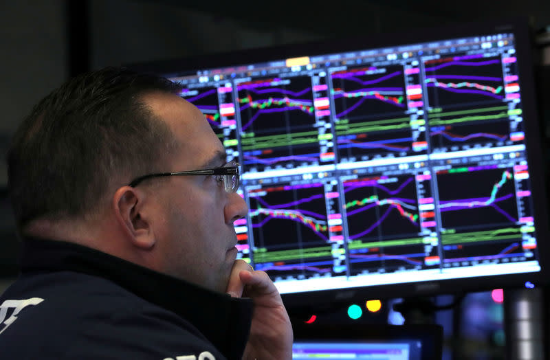 FILE PHOTO: A trader looks at price monitors as he works on the floor at the New York Stock Exchange (NYSE) in New York City, New York, U.S., December 4, 2018. REUTERS/Brendan McDermid/File Photo