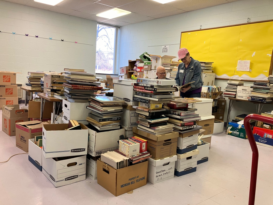 Volunteers Harold Kloc, of West Bloomfield, and Elayne Gross, of Oak Park, discuss pricing for a volume in the room devoted to rarities at the Bookstock sorting and shipping depot. The 20th Bookstock charity book and media sale runs Sunday through April 14 at Laurel Park Place in Livonia. “You start looking at these books,” Kloc says, “it’s an education.”