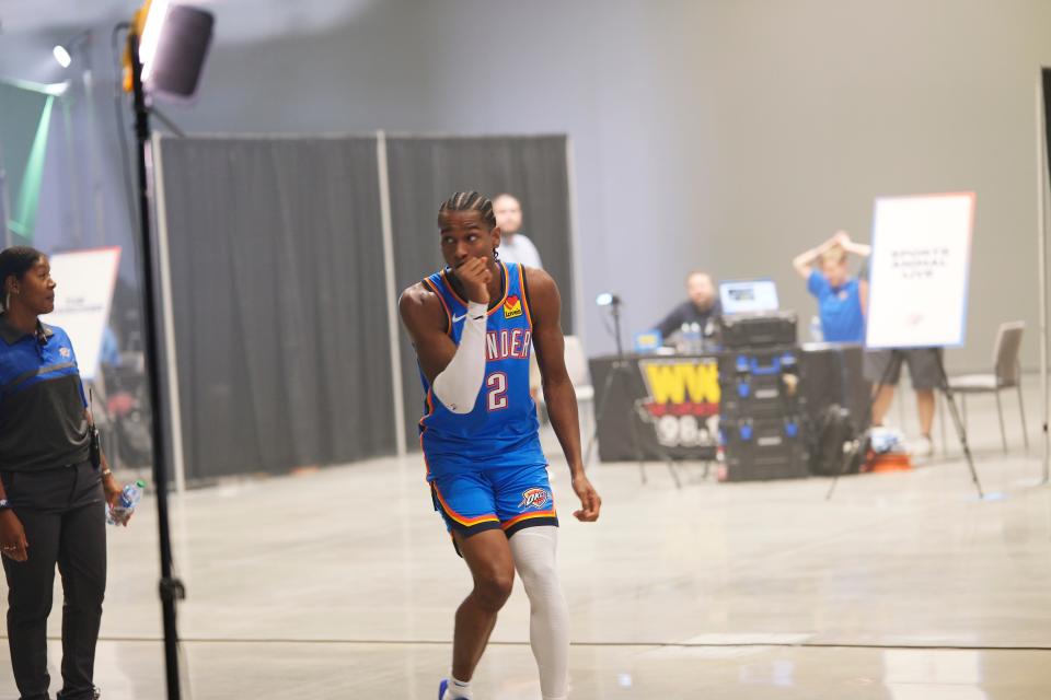 Shai Gilgeous-Alexander (2) reacts when he realizes he’s in the background of an interview at Thunder Media Day, held in the Oklahoma City Convention Center on Monday, Oct. 2, 2023.