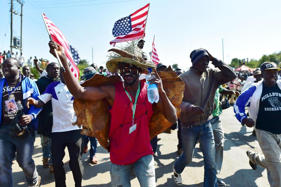 <p>Residents of Nyang’oma village in Kogelo wave US flags as they gather by the side of the road to wait for former US President, Barak Obama to arrive on July 16, 2018 for the opening of the Sauti Kuu Resource Centre, founded by his half-sister, Auma Obama at Kogelo in Siaya county, western Kenya. – Obama is in the East African nation for the first time since he left the US presidency and met with President Uhuru Kenyatta and opposition leader Raila Odinga in Nairobi. (Photo: Tony Karumba/AFP/Getty Images) </p>