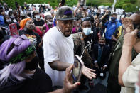 People gather outside the municipal building after at least one Pasquotank County Sheriff's deputy shot and killed a Black man, Andrew Brown Jr., while executing a search warrant, the sheriff's office said, Wednesday, April 21, 2021, in Elizabeth City, N.C. The deputy was wearing an active body camera at the time of the shooting, said Sheriff Tommy Wooten II, who declined to say how many shots the deputy fired or release any other details, citing a pending review by the State Bureau of Investigation. (AP Photo/Gerry Broome)