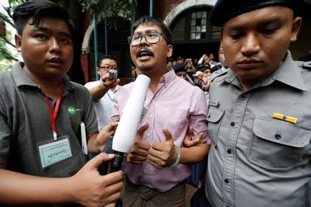Detained Reuters journalist Wa Lone is escorted by police while leaving Insein court in Yangon, Myanmar July 2, 2018. REUTERS/Ann Wang