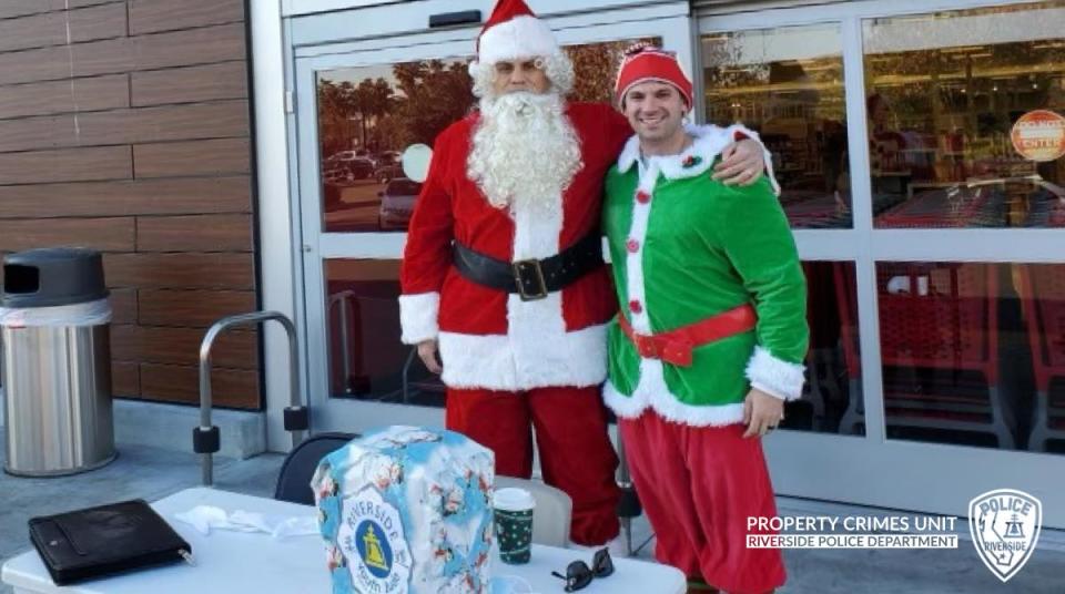 Two police officers dressed as Santa and an elf.