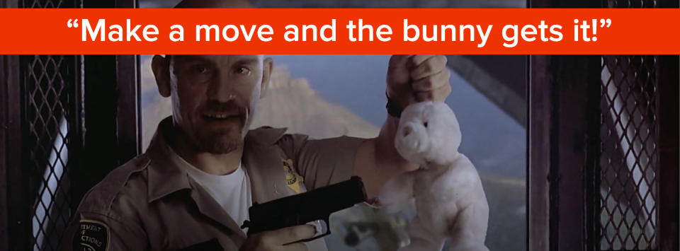 John Malkovich holds a stuffed animal at gunpoint and says, "make a move and the bunny gets it"