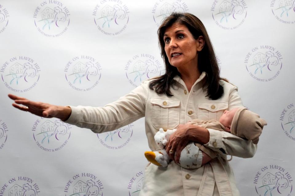PHOTO: Republican presidential candidate former UN Ambassador Nikki Haley holds a patient's baby while speaking at Hope on Haven Hill, a wellness center, Jan. 17, 2024, in Rochester, N.H.  (Robert F. Bukaty/AP)