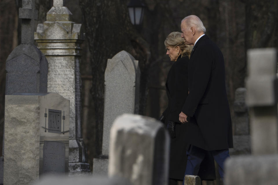 President Joe Biden and first lady Jill Biden walk between tombstones to attend Mass at St. Joseph on the Brandywine Catholic Church in Wilmington, Del., on Sunday, Dec. 18, 2022. Sunday marks the 50th anniversary of the car crash that killed Biden's first wife Neilia Hunter Biden and 13-month-old daughter Naomi. (AP Photo/Manuel Balce Ceneta)