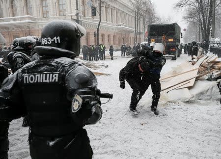 Riot police detain anti-government protesters, as service members of the National Guard remove a protest tent camp, near the parliament building in Kiev, Ukraine March 3, 2018. REUTERS/Gleb Garanich