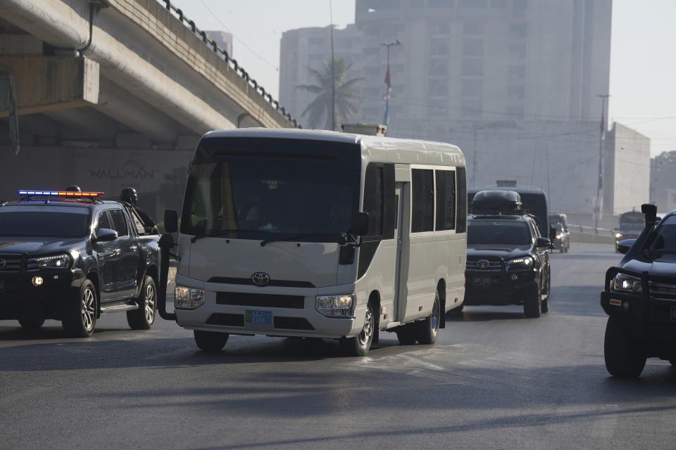 A special unit of national security forces escort a convoy of vehicles carrying New Zealand cricket team arriving to attend training session in the National Stadium, in Karachi, Pakistan, Friday, Dec. 23, 2022. (AP Photo/Fareed Khan)