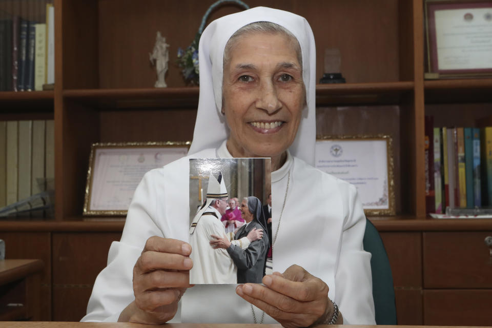 In this Aug. 27, 2019, photo, ST. Mary's School Vice Principal Sister Ana Rosa Sivori shows a picture taken with Pope Francis, at the girls' school in Udon Thani, about 570 kilometers (355 miles) northeast of Bangkok, Thailand. Sister Ana Rosa Sivori, originally from Buenos Aires in Argentina, shares a great-grandfather with Jorge Mario Bergoglio, who, six years ago, became Pope Francis. So, she and the pontiff are second cousins. (AP Photo/Sakchai Lalit)